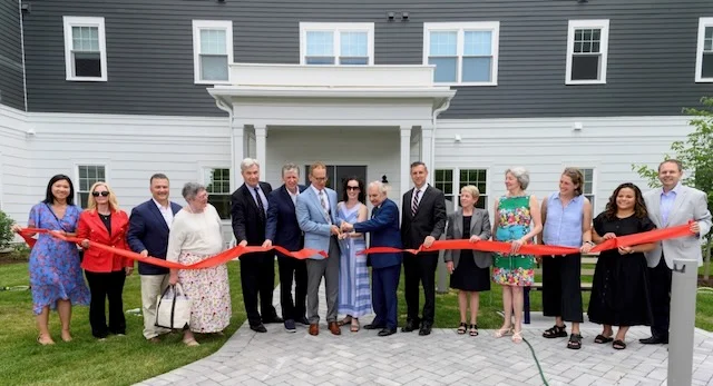 People cut ribbon of a new affordable development